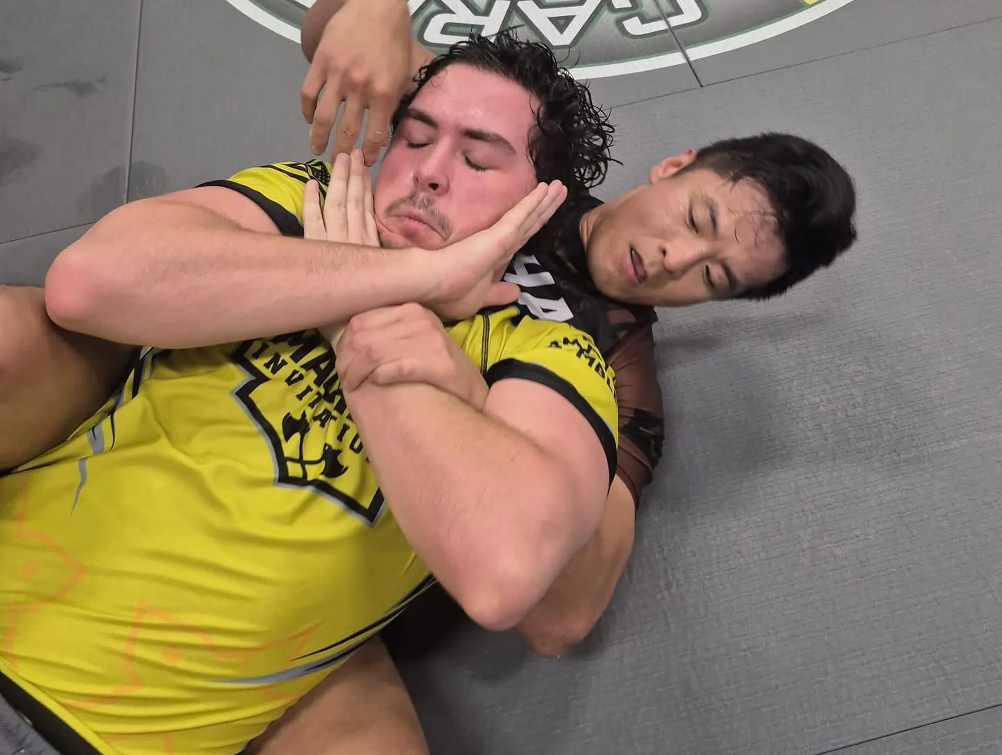 Adult students rolling during a no-gi Brazilian Jiu Jitsu class at Sampson Jiu Jitsu Academy