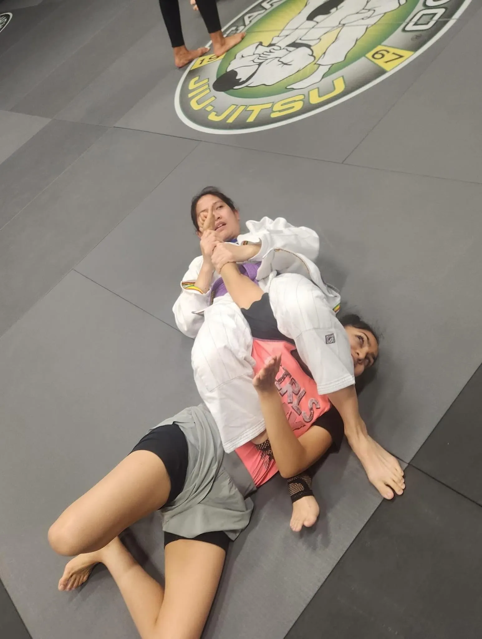 Adult students training a submission during live Brazilian Jiu Jitsu rolling