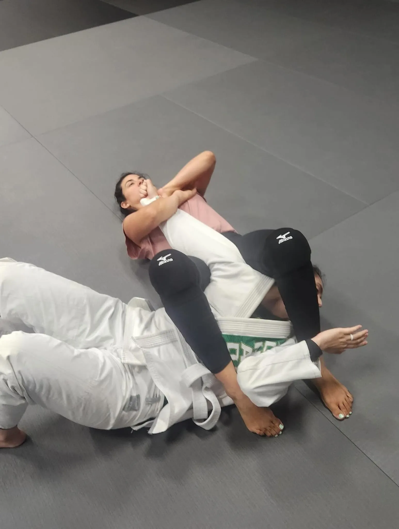 Adult students drilling Brazilian Jiu Jitsu technique on the mat