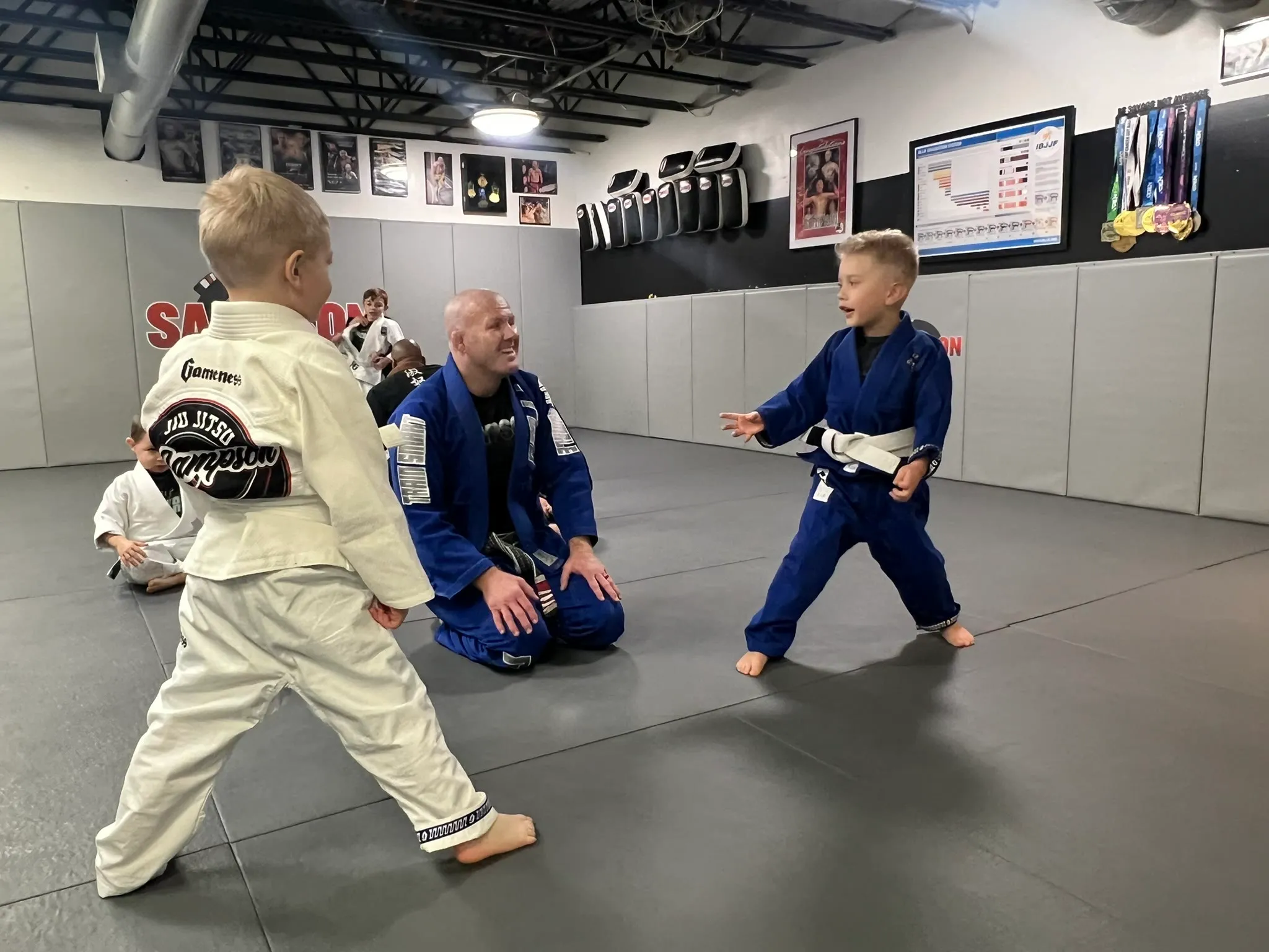 A folded Brazilian Jiu Jitsu gi and belt on the mat